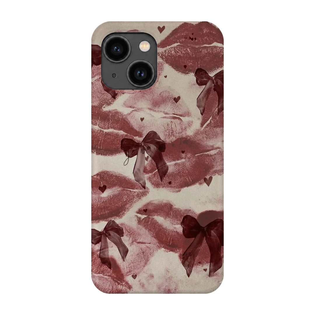 Kiss Marks and Bows 3D Print iPhone 13 Phone Case, back view; red lip-print graphics and ribbon bows on a pale pink background