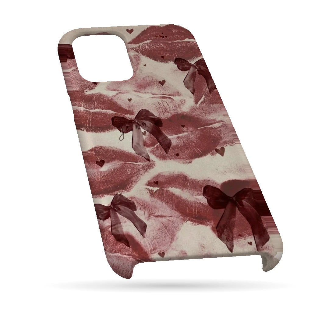 Kiss Marks and Bows 3D Print iPhone 13 Phone Case, bottom view; red lip-print graphics and ribbon bows on a pale pink background