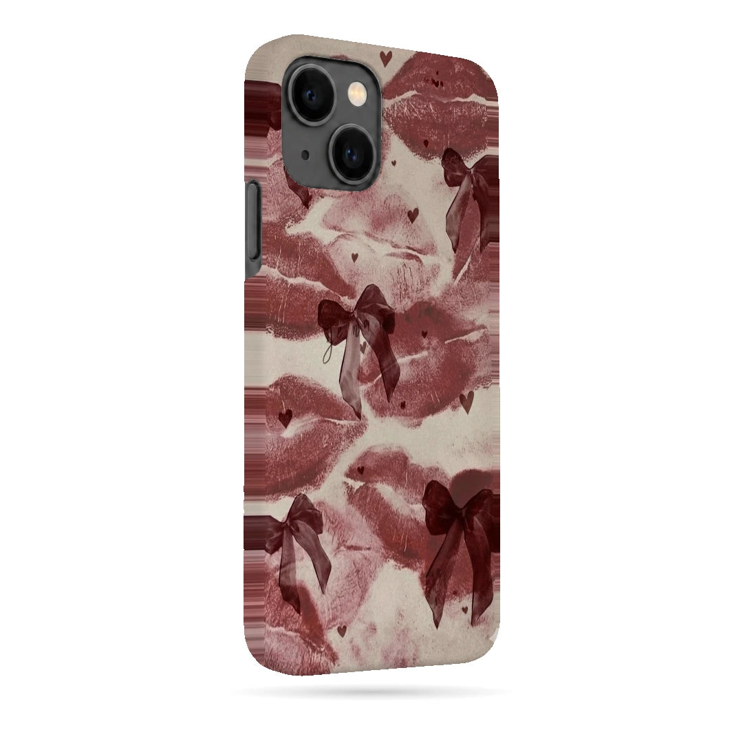 Kiss Marks and Bows 3D Print iPhone 13 Phone Case, right-side view; red lip-print graphics and ribbon bows on a pale pink background