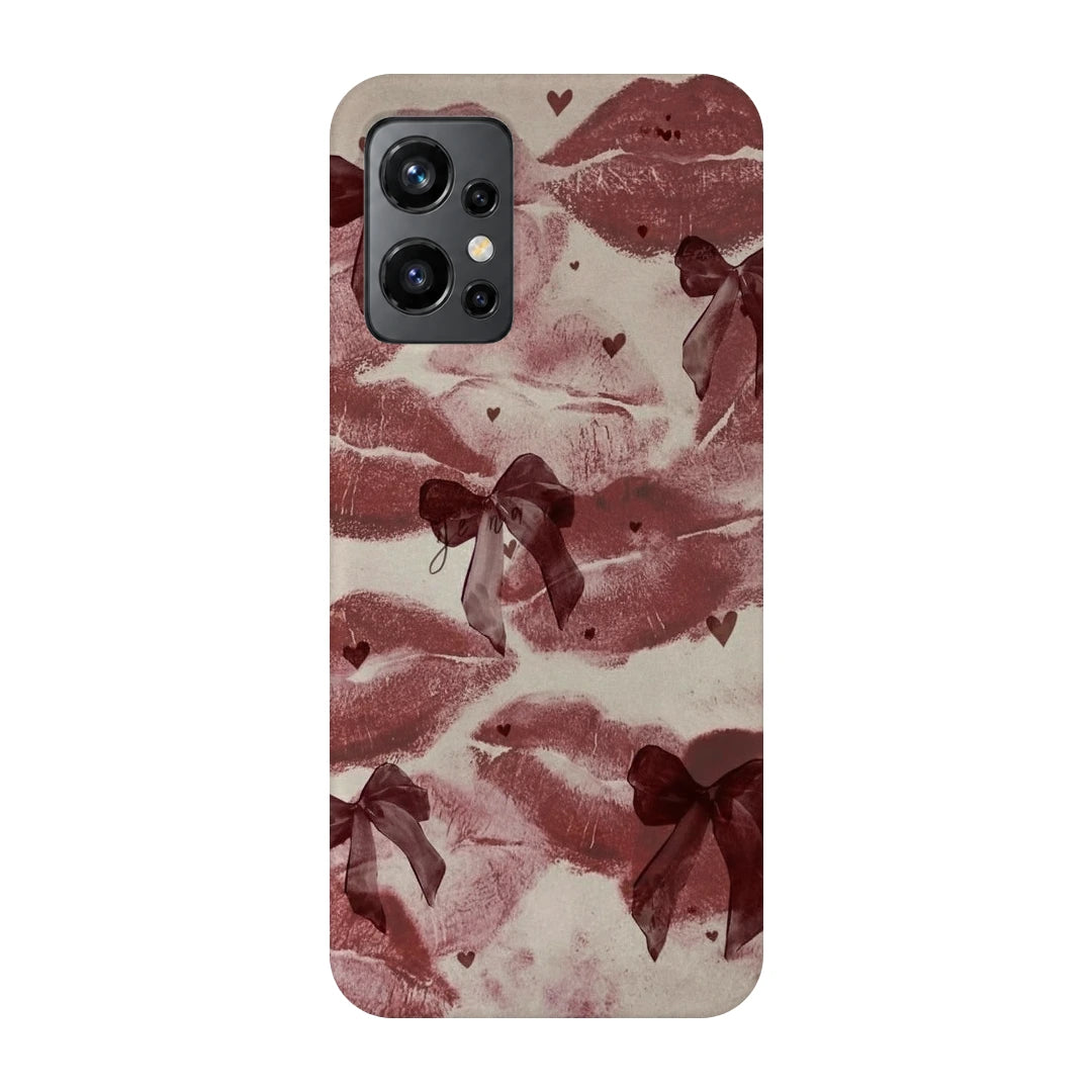 Kiss Marks and Bows 3D Print OnePlus 9R Phone Case, back view; red lip-print graphics and ribbon bows on a pale pink background