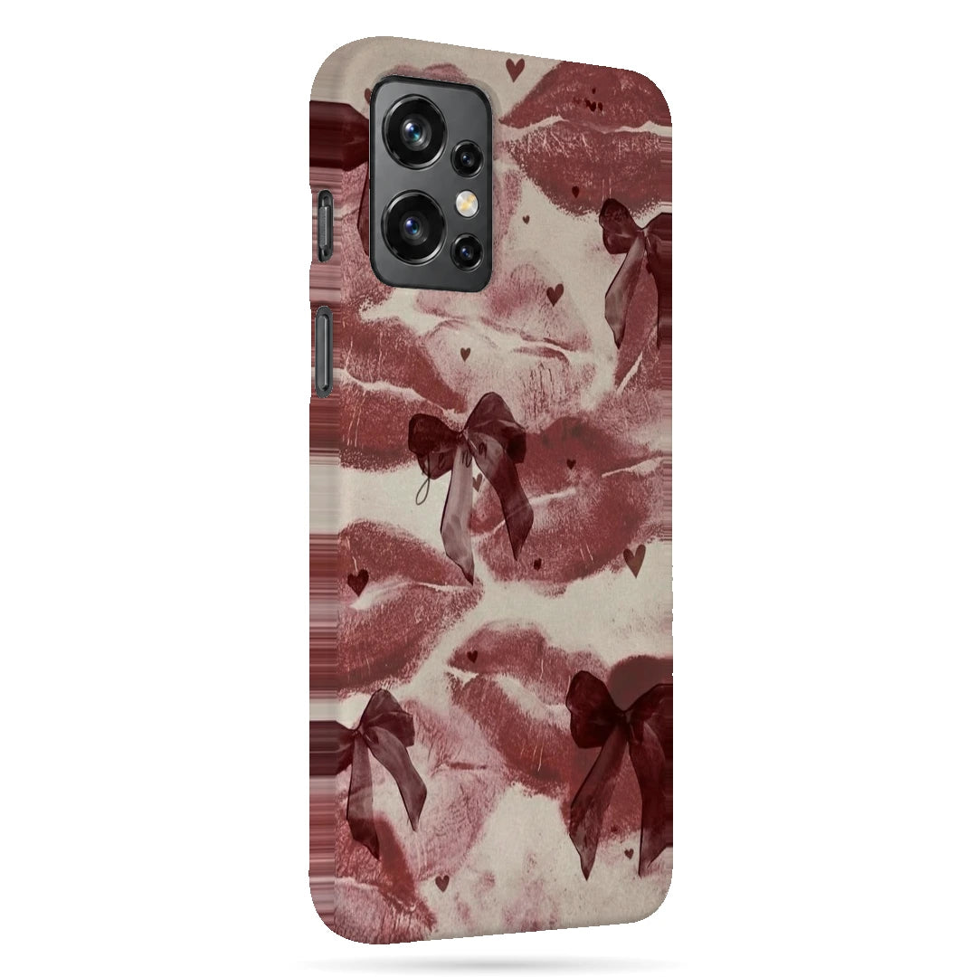 Kiss Marks and Bows 3D Print OnePlus 9R Phone Case, right-side view; red lip-print graphics and ribbon bows on a pale pink background